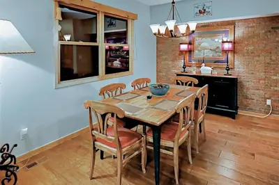 a dining room with a wooden table and chairs at Family Friendly 3 Bedroom Vacation Rental In West Keystone Resort Along The Snake River With Pool And Hot Tub in Keystone