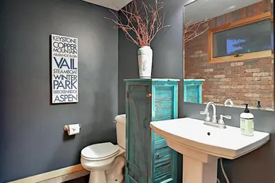 a bathroom with a green cabinet and a sink at Family Friendly 3 Bedroom Vacation Rental In West Keystone Resort Along The Snake River With Pool And Hot Tub in Keystone