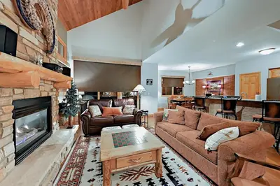 a living room with a couch and a fireplace at Family Friendly 3 Bedroom Vacation Rental In West Keystone Resort Along The Snake River With Pool And Hot Tub in Keystone