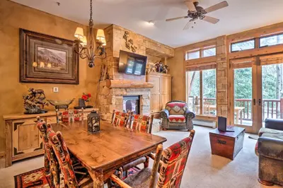 a dining room with a table and a fireplace at Ski-Out Keystone Resort Condo with Private Balcony in Keystone