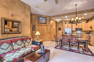 a living room with a couch and a kitchen at Ski-Out Keystone Resort Condo with Private Balcony in Keystone
