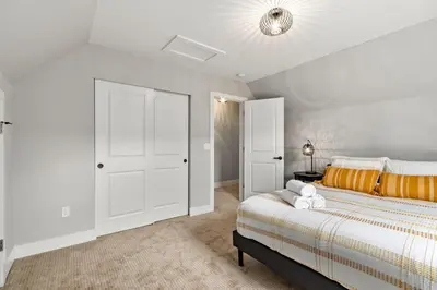 a white bedroom with a bed and a ceiling at Spacious Downtown Apartment - Walk to Old Town FC! in Fort Collins