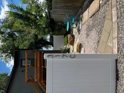 a white garage door in front of a building at Spacious Downtown Apartment - Walk to Old Town FC! in Fort Collins