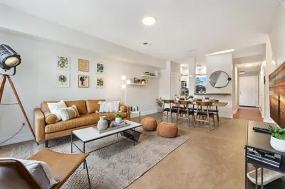 a living room with a couch and a table at Mid-century Mod Retreat near Old Town - Free Bikes in Fort Collins