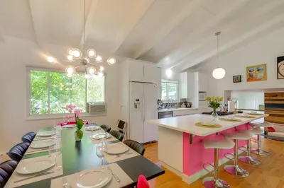 a kitchen and dining room with a table and chairs at The Modern Ridge House with Yard in Wheat Ridge in Wheat Ridge