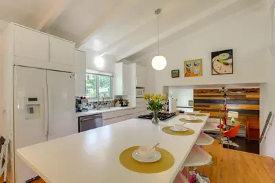 a kitchen with a large white island in a room at The Modern Ridge House with Yard in Wheat Ridge in Wheat Ridge