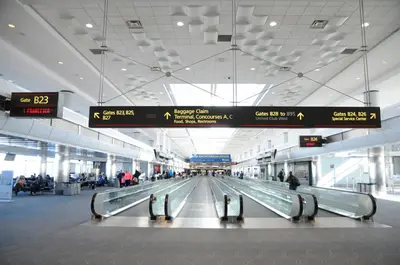 an airport baggage claim area with people waiting for their luggage at Staybridge Suites Denver - Central Park by IHG in Denver