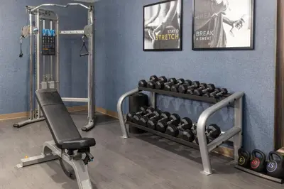 a fitness room with a gym with weights at Staybridge Suites Denver - Central Park by IHG in Denver