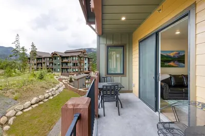 a balcony with a table and chairs on a house at 202 Clearwater Lofts condo in Keystone