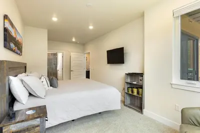 a bedroom with a large bed and a tv at 202 Clearwater Lofts condo in Keystone