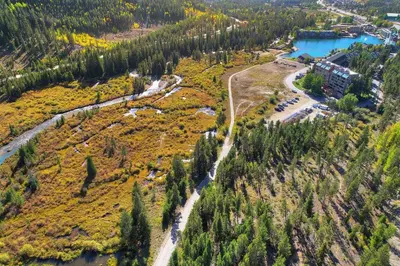 an aerial view of a river and a forest at 202 Clearwater Lofts condo in Keystone