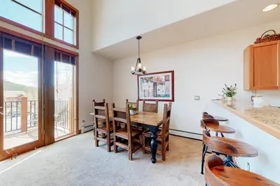 a kitchen and dining room with a table and chairs at Antlers Gulch #304 in Keystone