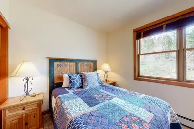 a bedroom with a bed and a window at Antlers Gulch #304 in Keystone