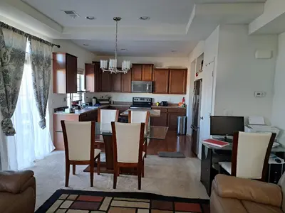 a kitchen and living room with a table and chairs at Ram comfort in Denver