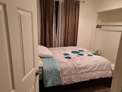 a bedroom with a bed with blue flowers on it at Ram comfort in Denver