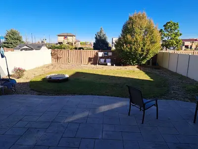 a patio with two chairs in a yard at Ram comfort in Denver