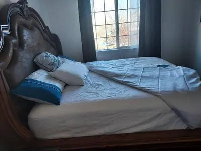 a bed with pillows on it with a window at Ram comfort in Denver