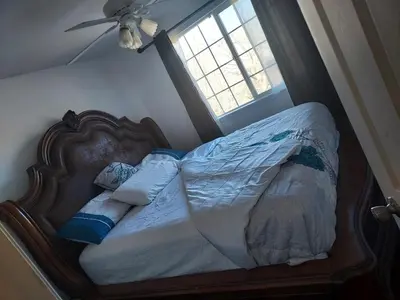 a bed in a bedroom with a window at Ram comfort in Denver