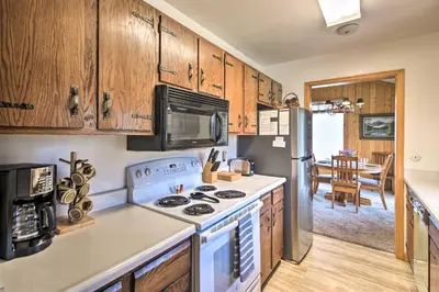 a kitchen with a stove and a refrigerator at Rocky Mountain Breezes Cabin Grill and Deck! in Estes Park