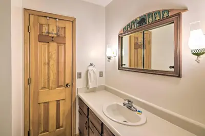 a bathroom with a sink and a mirror at Rocky Mountain Breezes Cabin Grill and Deck! in Estes Park