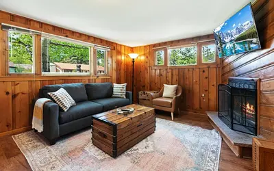 a living room with a couch and a fireplace at Misty Mountain Lodge in Estes Park