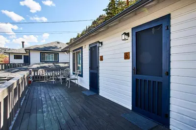a deck with a blue door on a house at Misty Mountain Lodge in Estes Park