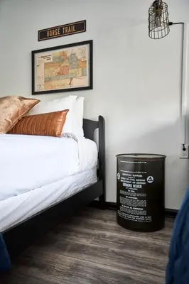 a room with a bed and a trash can at Misty Mountain Lodge in Estes Park