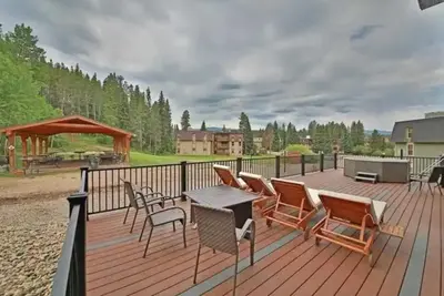 a deck with chairs and a table and a grill at Hi Country 816 in Winter Park
