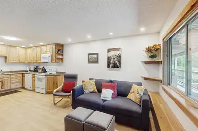 a living room with a couch and a kitchen at Hi Country 816 in Winter Park