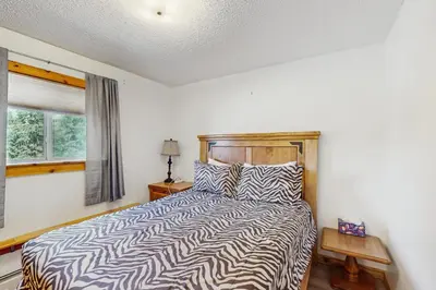 a bedroom with a bed with a zebra print bedspread at Hi Country 816 in Winter Park