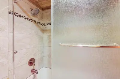 a shower with a glass door in a bathroom at Hi Country 816 in Winter Park