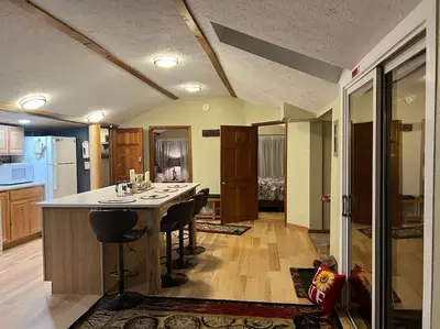 a kitchen with a large island in the middle of a room at Thorpe On The Water. Creekside Nederland Cabin. in Nederland