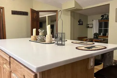 a kitchen counter with candles on top of it at Thorpe On The Water. Creekside Nederland Cabin. in Nederland