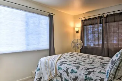 a bedroom with a bed and a large window at Cozy Condo on Fall River - 1 Mile to RMNP Gate! in Estes Park
