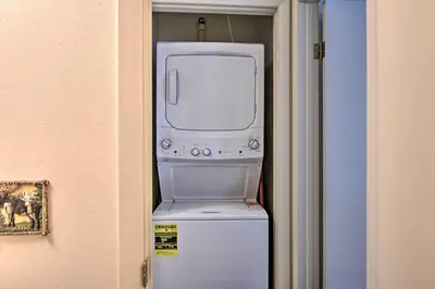 a washer and dryer sitting on top of a refrigerator at Cozy Condo on Fall River - 1 Mile to RMNP Gate! in Estes Park