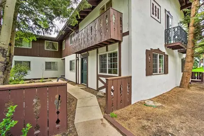 an exterior view of a house with a gate and balcony at Cozy Condo on Fall River - 1 Mile to RMNP Gate! in Estes Park