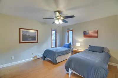 a bedroom with two beds and an american flag on the wall at Cozy Red Feather Lakes Retreat with Deck and Yard in Red Feather Lakes
