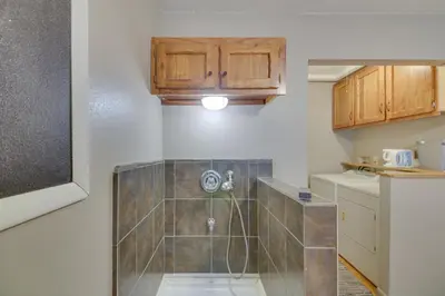 a small kitchen with a shower in a room at Cozy Red Feather Lakes Retreat with Deck and Yard in Red Feather Lakes