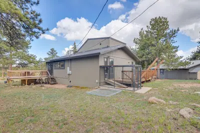 a small house with a porch and a deck at Cozy Red Feather Lakes Retreat with Deck and Yard in Red Feather Lakes