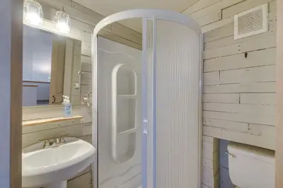 a white bathroom with a sink and a shower at Cozy Red Feather Lakes Retreat with Deck and Yard in Red Feather Lakes