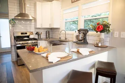 a kitchen with a counter top with a bowl of fruit at Cozy Bungalow Hot Tub & Fire Pit, Walk Downtown in Loveland