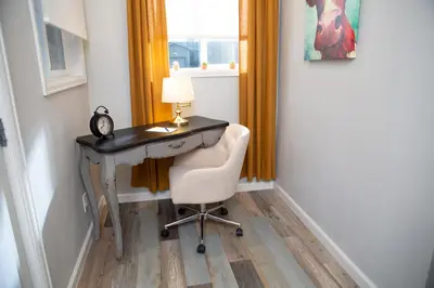 a desk with a lamp and a chair in a room at Cozy Bungalow Hot Tub & Fire Pit, Walk Downtown in Loveland