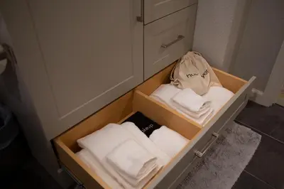 a drawer with towels and a bag in a room at Cozy Bungalow Hot Tub & Fire Pit, Walk Downtown in Loveland