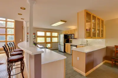 a kitchen with white counter tops and wooden cabinets at Spacious Townhome Near Main St and Lake Dillon! in Frisco