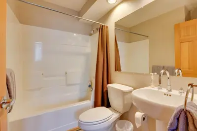 a bathroom with a toilet and a sink and a tub at Spacious Townhome Near Main St and Lake Dillon! in Frisco