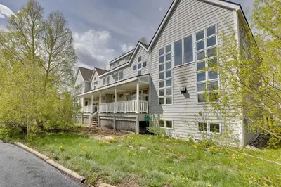 a large white house with a yard at Spacious Townhome Near Main St and Lake Dillon! in Frisco