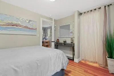 a bedroom with a bed and a desk and a window at 1147 Vine St in Denver