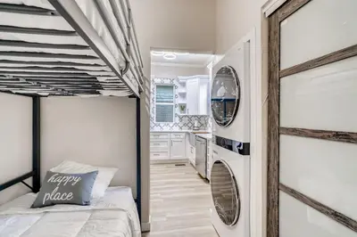 a bedroom with a bed and a washer and dryer at 1020 E 24th Ave in Denver