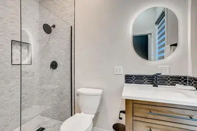a bathroom with a shower and a toilet and a sink at 1020 E 24th Ave in Denver