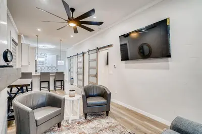 a living room with two chairs and a tv on a wall at 1020 E 24th Ave in Denver